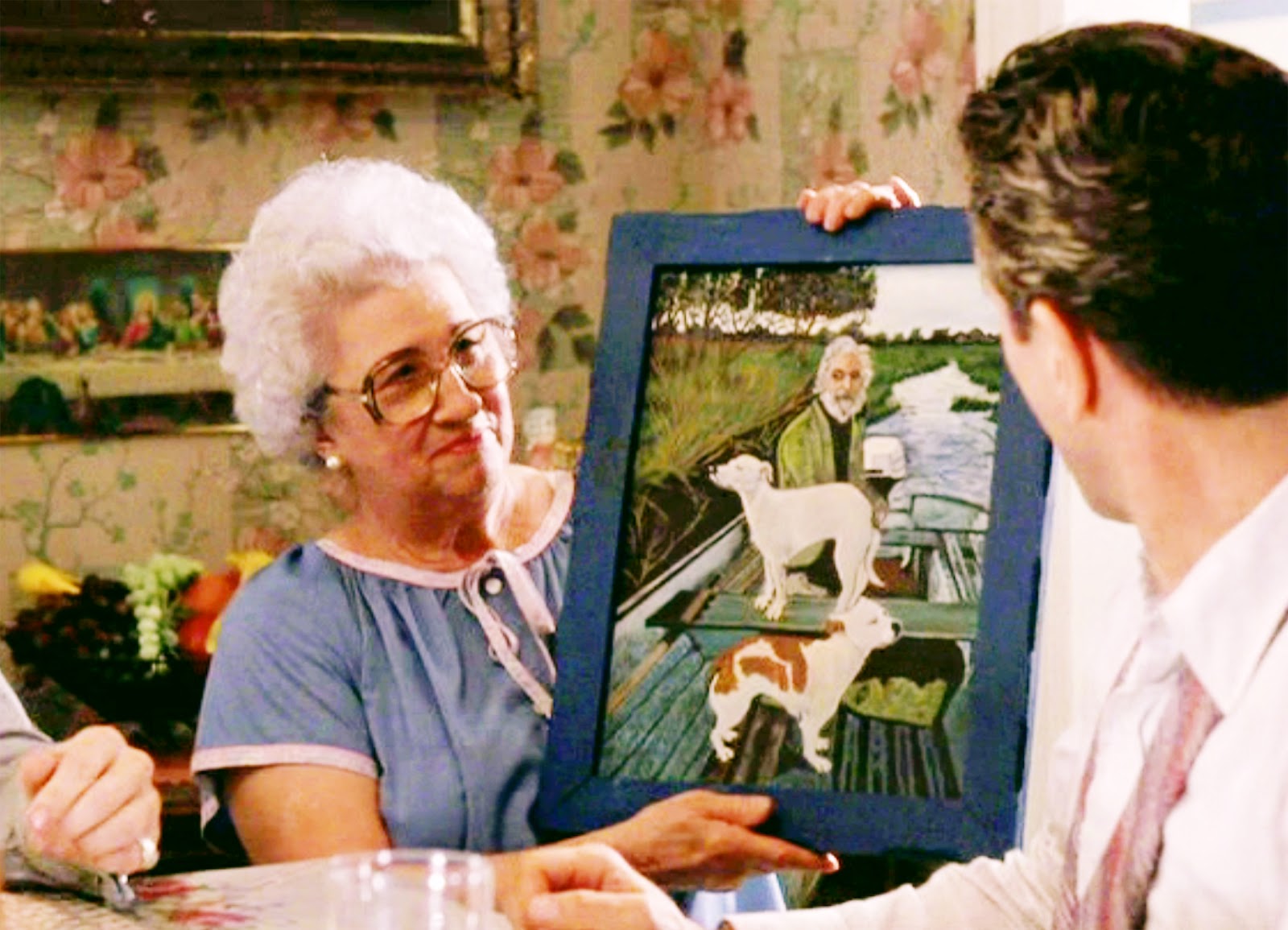 tommys-mom-holding-the-painting-at-table tommys-mom-holding-the-painting-at-table